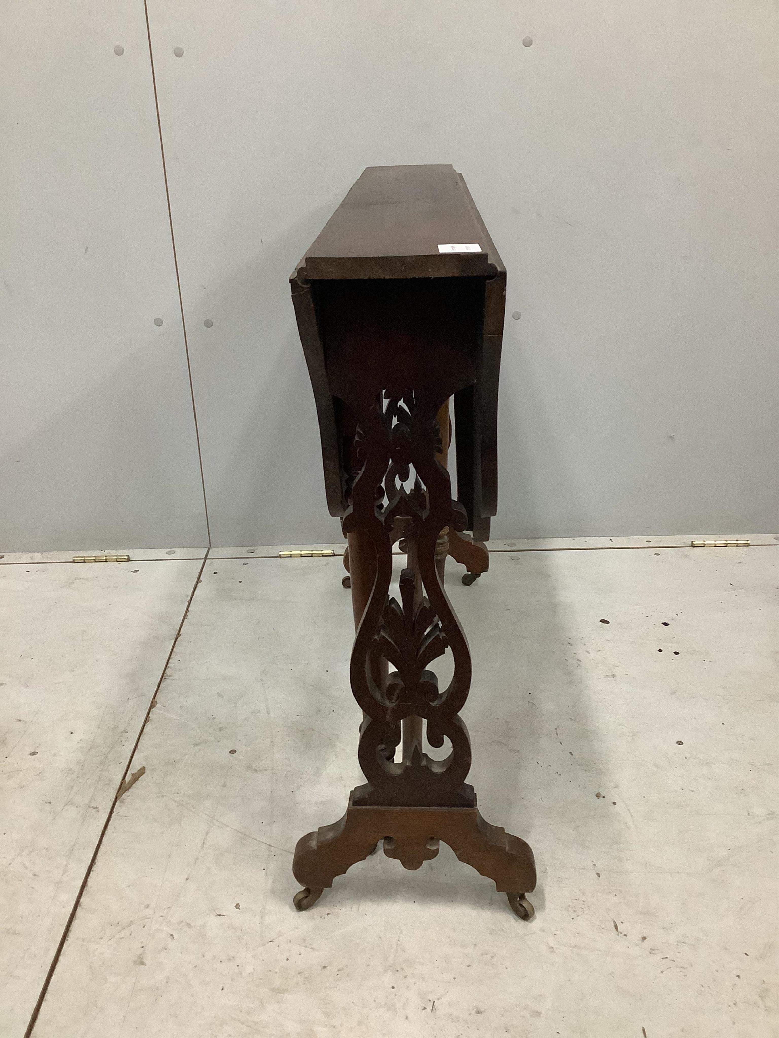 A Victorian walnut Sutherland table with shaped oval top, width 88cm, depth 16cm, height 72cm. Condition - fair